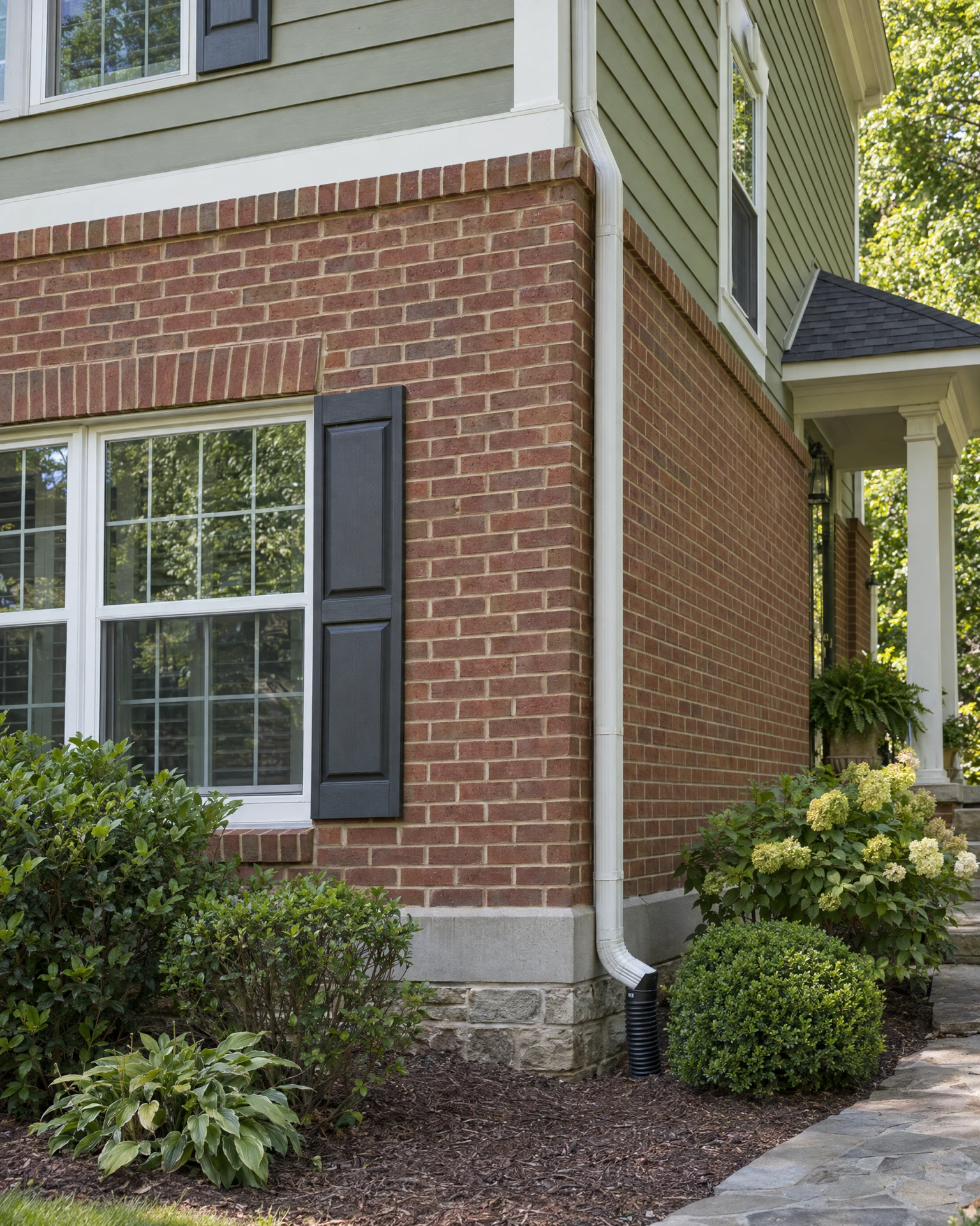 Brick, siding, foundation transition, and exterior details
